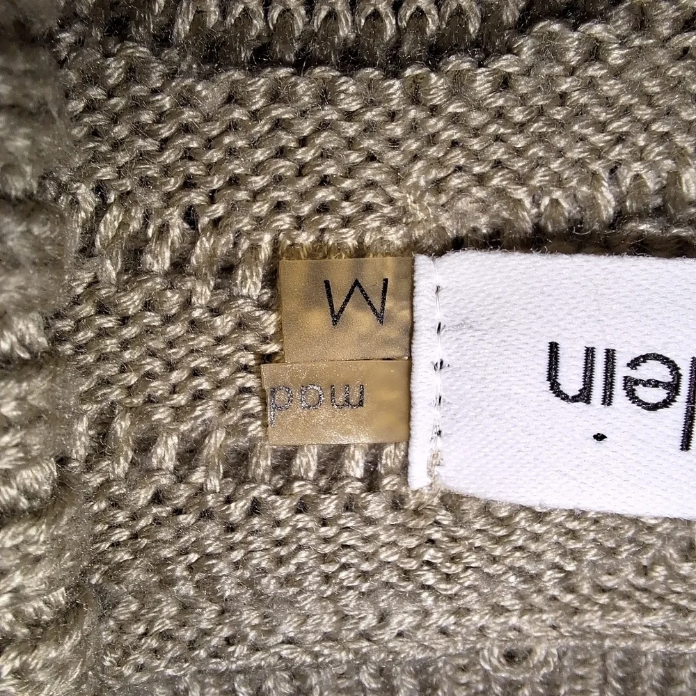 A Calvin Klein faux wrap ribbed knitted sweater dress in a ladies size medium.